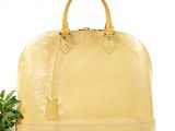 yellow louis vuitton handbag with a rose on a white background