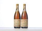 two bottles of wine sitting on top of a table