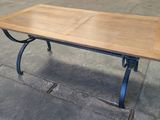 a wooden table with metal legs and a wooden top