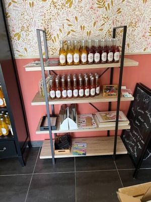 many jars of honey on the shelves in the store