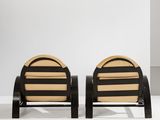 a pair of black and wicker chairs with black legs