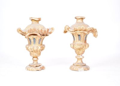 two gold vases sitting next to each other on a white surface
