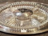 a glass tray with a silver lid on a table