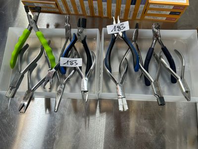 many different types of pliers on display in a store