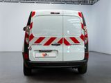 a white van with red and white stripes parked in a room