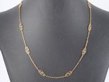 a gold chain necklace on a mannequin mannequin