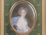 portrait of a young girl in a blue dress with a gold frame