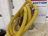 a yellow hose sitting on top of a counter next to a sign
