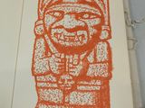 an orange and white drawing of a statue on a book