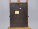 a wooden easel with a black door and a sign on it