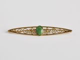 une barrette à cheveux « broche » dorée et verte