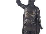 bronze statue of a man holding a bird and a bird in his hand