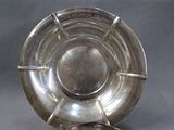 a silver plate with a spoon and a spoon rest on it