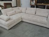 a large sectional couch with pillows on it in a room