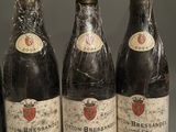 six bottles of wine are lined up on a table