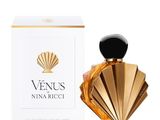 a bottle of perfume next to a box on a white surface