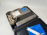 un ordinateur portable posé sur une valise en plastique