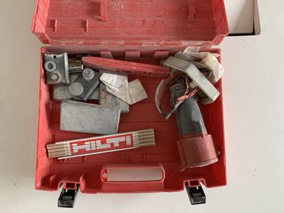 a red tool box with tools in it on a table