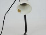 a white lamp with a black cord on it