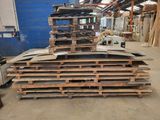 a large pile of pallets in a warehouse