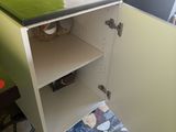 a small cabinet with a green top in a kitchen