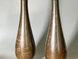 two vases sitting next to each other on a table