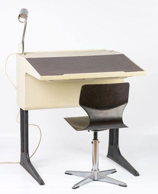 a desk with a chair and a lamp on top of it