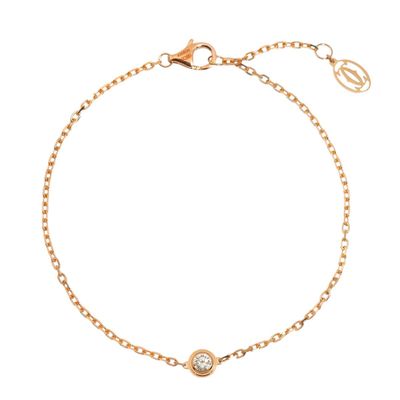 a gold bracelet with a white diamond on a chain
