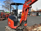 a small excavator that is parked in a parking lot
