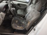the interior of a car with the door open and the driver ' s seat down