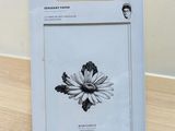 a white box with a black and white drawing of a flower on it