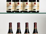 several bottles of wine sit on a glass shelf in front of a white background