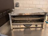 a toaster oven sitting on top of a table in a kitchen