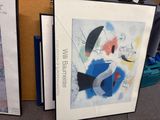 two framed art pieces sitting on the floor next to each other
