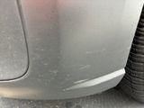 a close up of a car ' s front bumper and tire