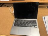 a laptop that is sitting on a desk with papers