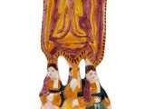 a figurine of a woman and a man holding a flag