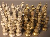 a lot of silver chess pieces on the table