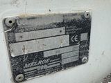 a metal sign on the side of a white wall