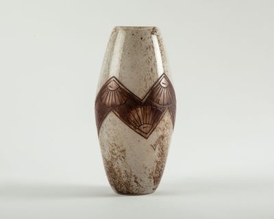 brown and white vase with geometric design on it on a white surface