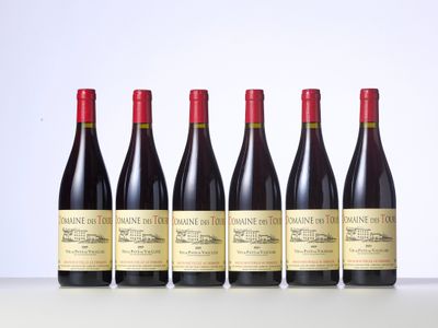 six bottles of wine are lined up on a table