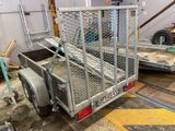 a trailer with a cage on the back of it in a garage