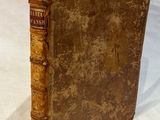 an old book that is sitting on a white surface