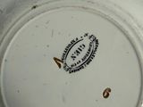 a white plate with a brown and black design on it