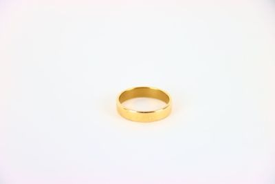 a close up of a gold ring on a white surface