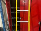 a ladder that is standing next to a red cabinet