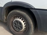 a white van that has a flat tire on the side of it