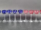 six wine glasses lined up in a row on top of a table