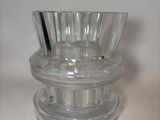 a clear glass vase on a table with a white background