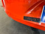 a sticker on the bumper of a car that is parked in a garage